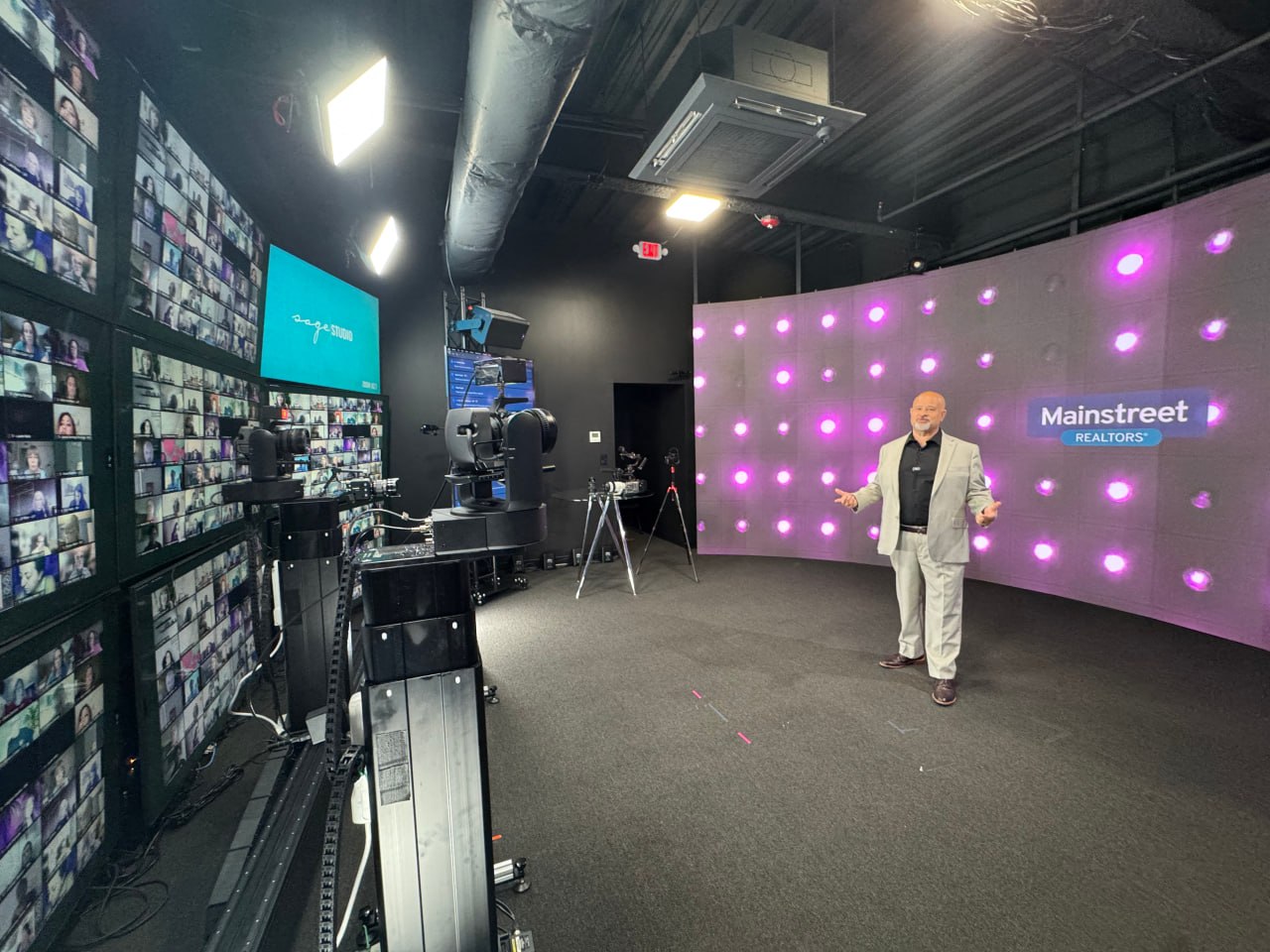 Matt presenting inside a broadcast studio with camera systems, audience screens, and a large LED stage